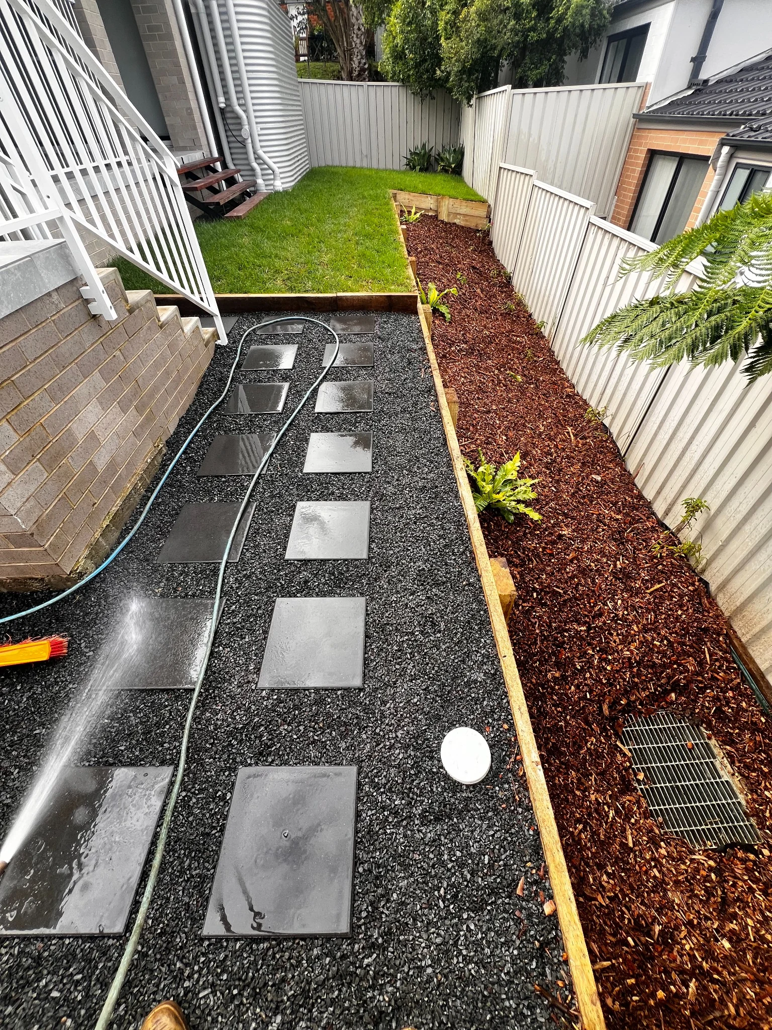 Stepping stones, fresh turf and a raised timber garden bed
