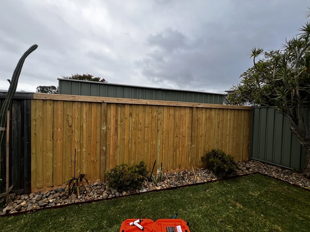 Timber privacy screen with a planted garden bed