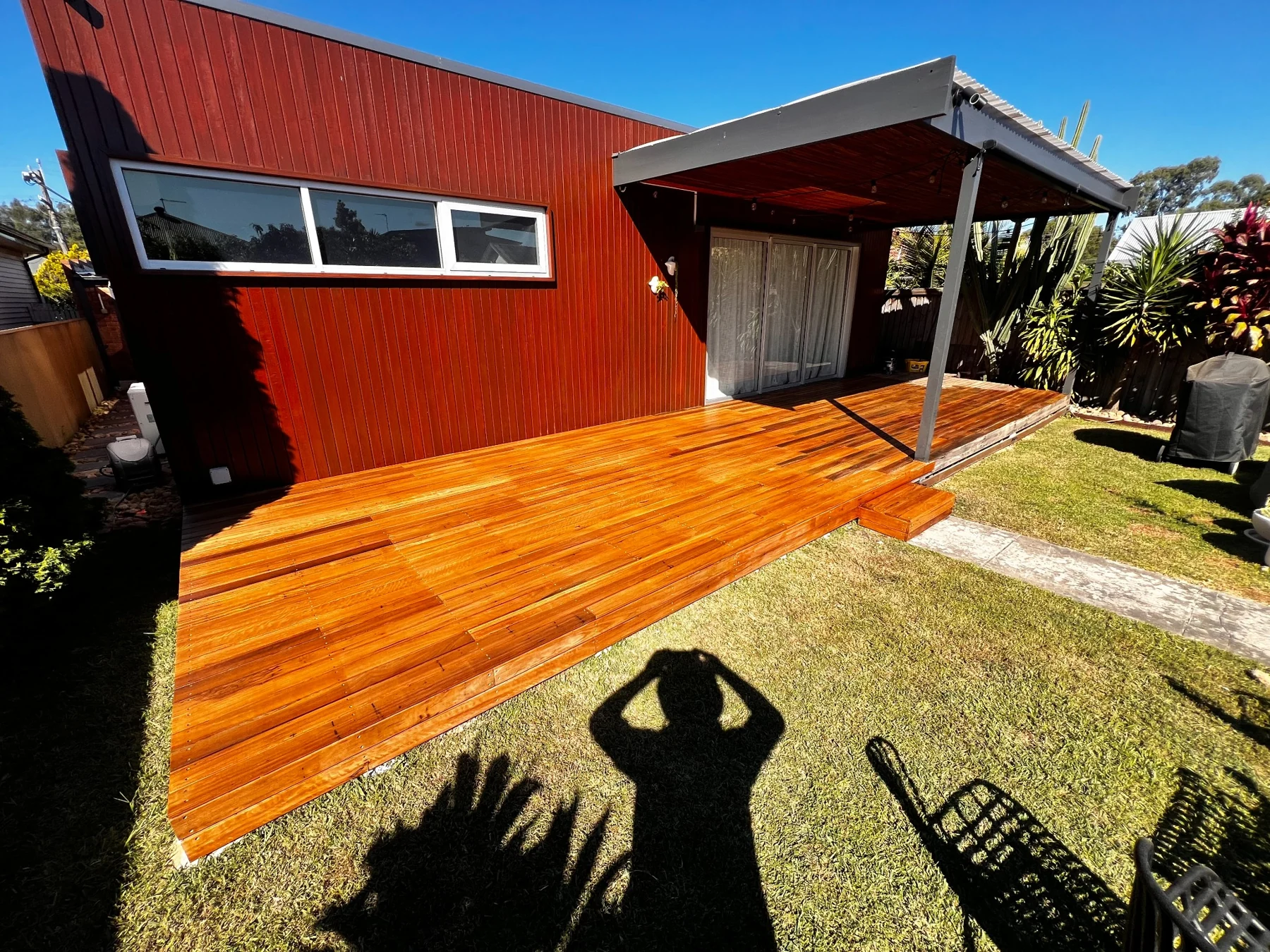 Timber outdoor living area beside an established lawn
